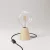 Table lamp with alder wood base and transparent bulb