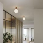 Metal wall lamp with porcelain-effect spherical bulb